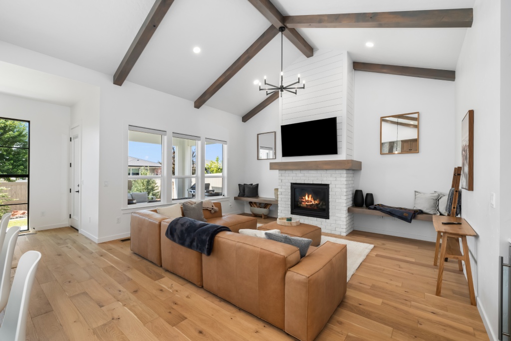 living room modern interior with vaulted ceilings and white brick fireplace.jpg (1)